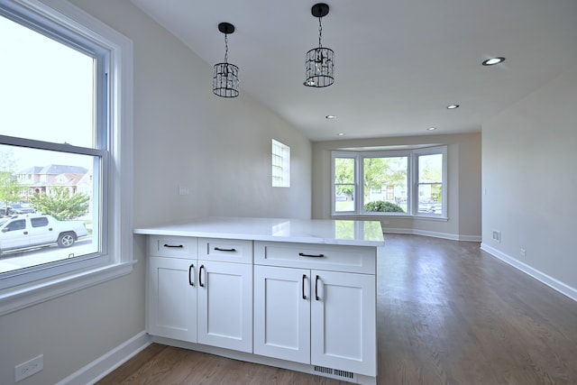 3001 N Neenah Ave, Chicago, IL 60634 - kitchen featuring a peninsula, baseboards, wood finished floors, white cabinets, and recessed lighting