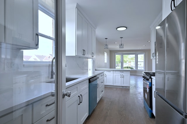 3001 N Neenah Ave, Chicago, IL 60634 - kitchen with stainless steel appliances, dark wood finished floors, white cabinetry, decorative light fixtures, and recessed lighting
