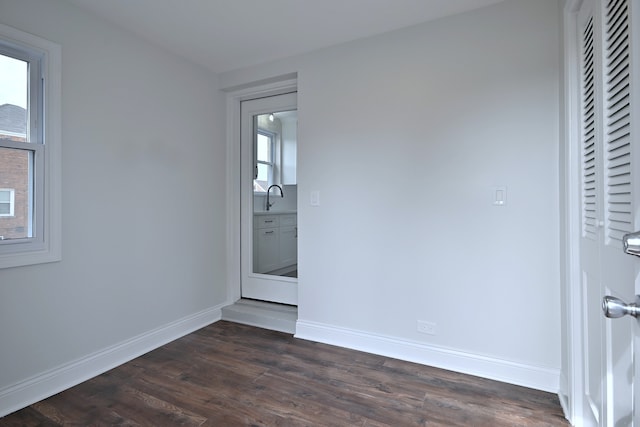 3001 N Neenah Ave, Chicago, IL 60634 - spare room with dark wood-type flooring, a sink, and baseboards