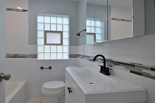 3001 N Neenah Ave, Chicago, IL 60634 - full bathroom with tile walls, toilet, a bathtub, vanity, and marble finish floors