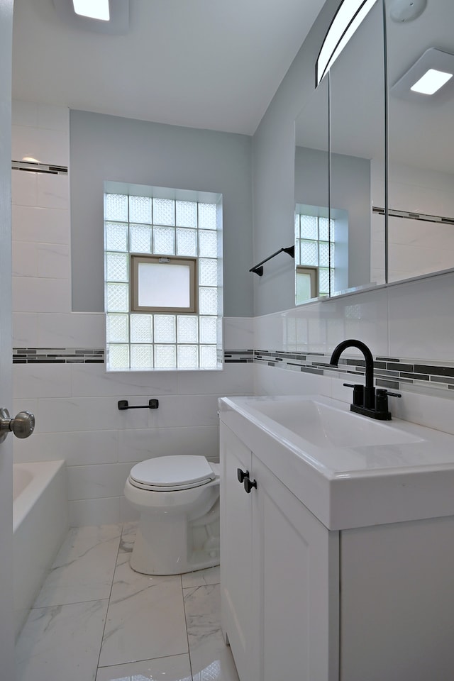 3001 N Neenah Ave, Chicago, IL 60634 - full bath featuring tile walls, toilet, vanity, marble look tile flooring, and shower / bath combination