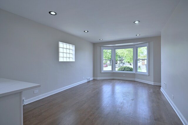 3001 N Neenah Ave, Chicago, IL 60634 - unfurnished room featuring dark wood-style floors, recessed lighting, and baseboards