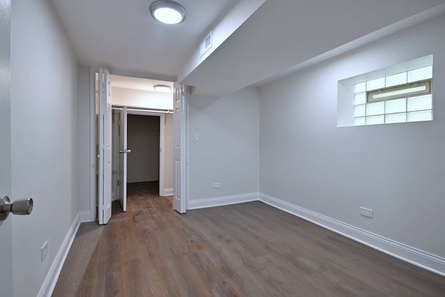 3001 N Neenah Ave, Chicago, IL 60634 - unfurnished bedroom with dark wood-style flooring, a spacious closet, baseboards, and a closet