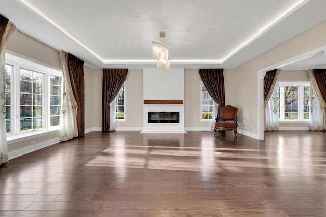 471 Stagecoach, Glen Ellyn, IL 60137 - unfurnished living room featuring healthy amount of natural light, a glass covered fireplace, wood finished floors, and baseboards