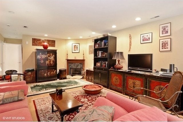 living room featuring a premium fireplace and recessed lighting