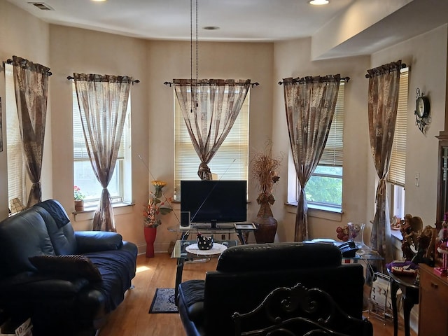 living area with wood finished floors, baseboards, and recessed lighting