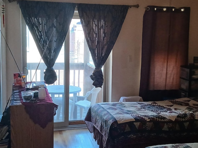 bedroom with wood finished floors and multiple windows