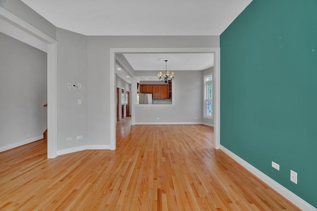28 S Van Nortwick Ave, Batavia, IL 60510 - unfurnished living room with a chandelier, light wood-type flooring, and baseboards