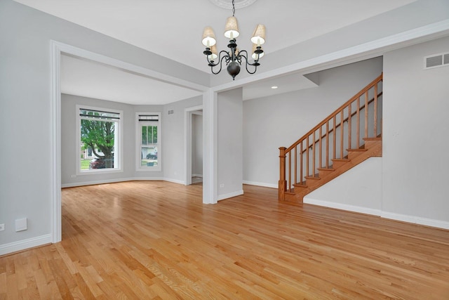 28 S Van Nortwick Ave, Batavia, IL 60510 - unfurnished room with a chandelier, light wood finished floors, stairway, and baseboards