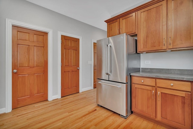 28 S Van Nortwick Ave, Batavia, IL 60510 - kitchen with freestanding refrigerator, light wood finished floors, brown cabinetry, and baseboards