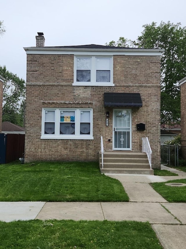939 W 123rd St, Calumet Park, IL 60827 - dutch colonial featuring a chimney, brick siding, and a front lawn