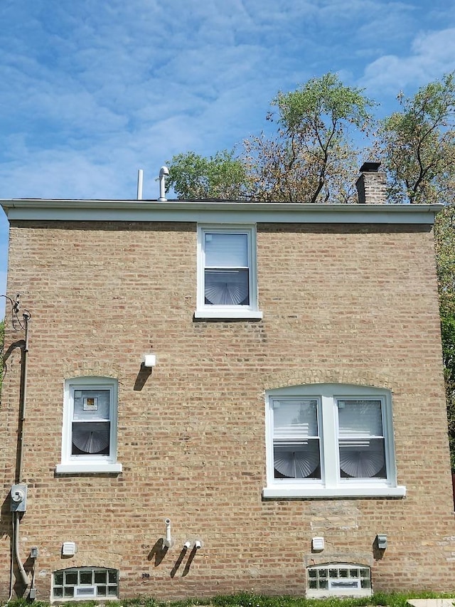 939 W 123rd St, Calumet Park, IL 60827 - view of property exterior with a chimney and brick siding