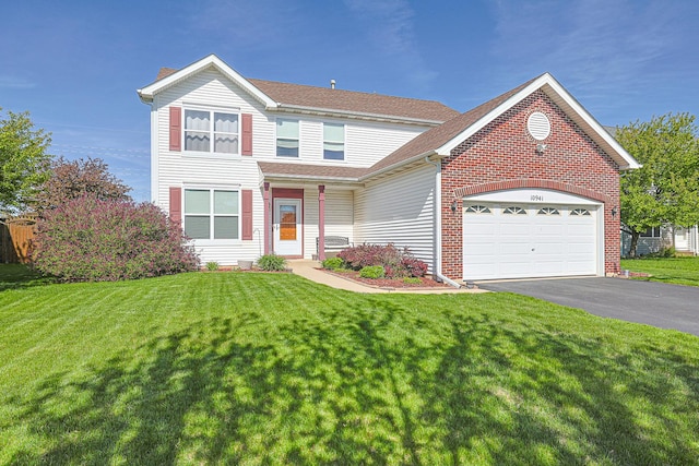 10941 Preston Pkwy, Huntley, IL 60142 - traditional home with asphalt driveway, an attached garage, a front yard, and brick siding