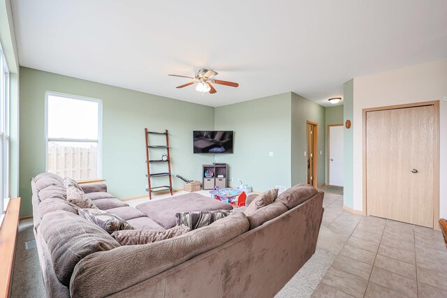 10941 Preston Pkwy, Huntley, IL 60142 - living area with a ceiling fan, light tile patterned floors, and baseboards