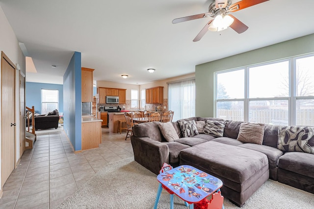 10941 Preston Pkwy, Huntley, IL 60142 - living area with light tile patterned floors and a ceiling fan