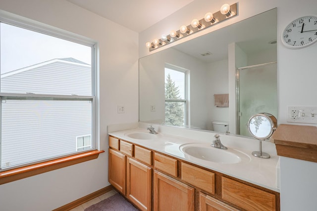 10941 Preston Pkwy, Huntley, IL 60142 - bathroom featuring toilet, a stall shower, double vanity, and tile patterned flooring