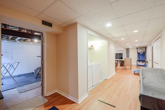 10941 Preston Pkwy, Huntley, IL 60142 - hallway with washing machine and dryer, light wood finished floors, recessed lighting, baseboards, and a drop ceiling