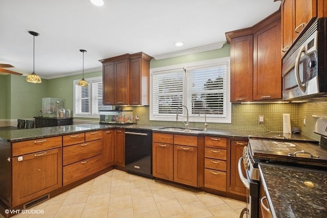 kitchen with appliances with stainless steel finishes, a sink, crown molding, backsplash, and a peninsula
