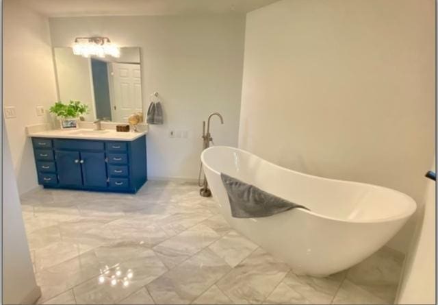 4775 Douglas Rd, Oswego, IL 60543 - full bath featuring vanity, a freestanding bath, and marble look tile flooring