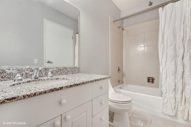 full bath featuring shower / tub combo with curtain, toilet, vanity, and tile patterned flooring