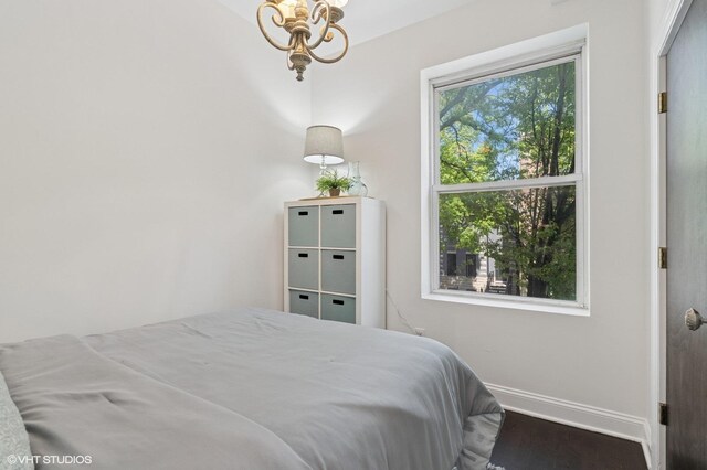 2328 N Oakley Ave Unit 2E, Chicago, IL 60647 - bedroom featuring baseboards, a chandelier, and wood finished floors