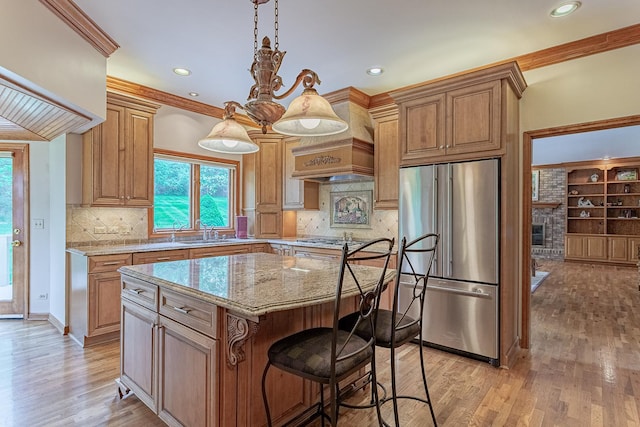 25410 N Cayuga Trl, Lake Barrington, IL 60010 - kitchen with appliances with stainless steel finishes, light stone countertops, a sink, a center island, and healthy amount of natural light