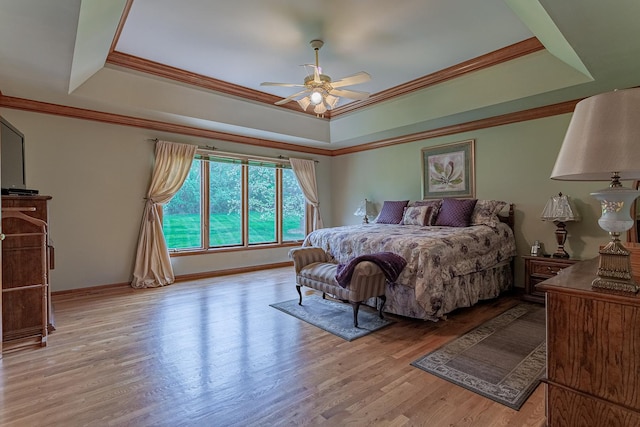 25410 N Cayuga Trl, Lake Barrington, IL 60010 - bedroom featuring a raised ceiling, wood finished floors, crown molding, baseboards, and ceiling fan