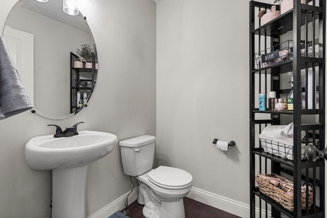 2011 Medical Center Dr, Monticello, IL 61856 - half bath featuring baseboards, toilet, wood finished floors, and a sink