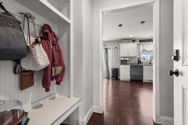 2011 Medical Center Dr, Monticello, IL 61856 - mudroom featuring dark wood-style floors, baseboards, and a textured ceiling