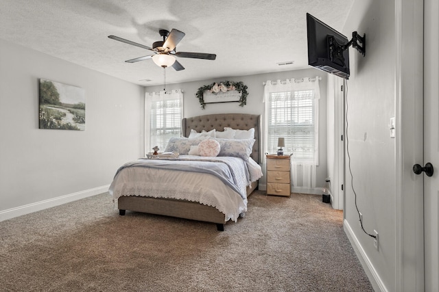 2011 Medical Center Dr, Monticello, IL 61856 - carpeted bedroom with a textured ceiling, baseboards, and a ceiling fan