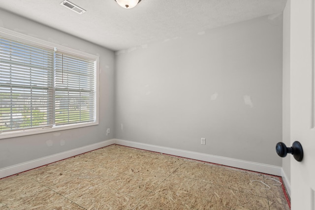 2011 Medical Center Dr, Monticello, IL 61856 - empty room featuring baseboards and a textured ceiling