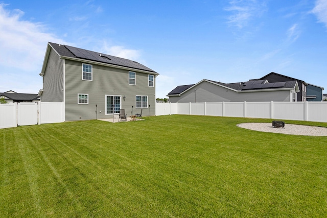 2011 Medical Center Dr, Monticello, IL 61856 - back of house with a fire pit, solar panels, a patio, and central AC
