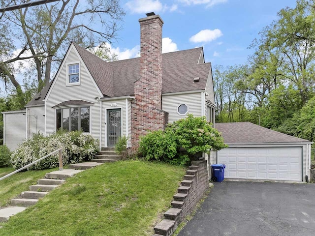 717 Front St, Lisle, IL 60532 - view of front facade with a chimney, a garage, a front lawn, and a shingled roof