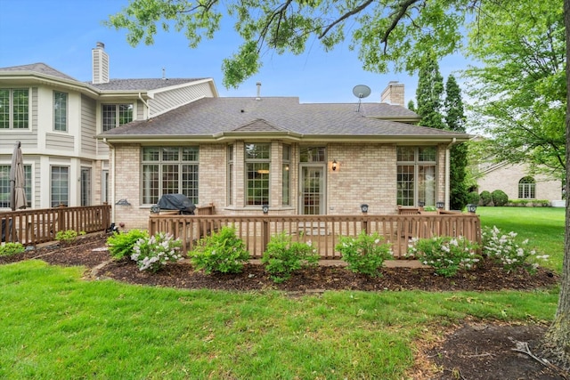 16 Pine Needles Dr, Lemont, IL 60439 - back of property featuring a chimney, brick siding, a deck, a yard, and roof with shingles