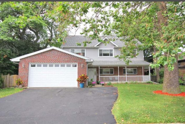 4310 Church St, Skokie, IL 60076 - view of front facade featuring asphalt driveway, an attached garage, a porch, and brick siding