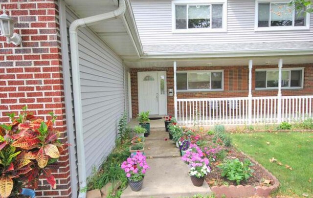 4310 Church St, Skokie, IL 60076 - entrance to property featuring brick siding, covered porch, and a yard