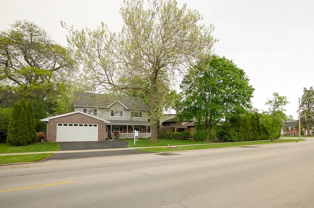 4310 Church St, Skokie, IL 60076 - traditional home with brick siding, asphalt driveway, a front lawn, and an attached garage