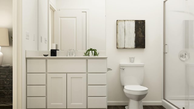full bathroom with toilet, a shower stall, vanity, and baseboards