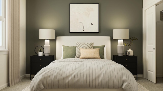 bedroom with light colored carpet and baseboards