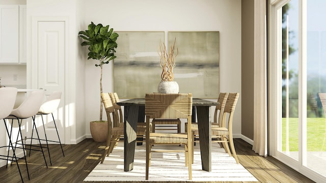 dining space with wood finished floors and baseboards