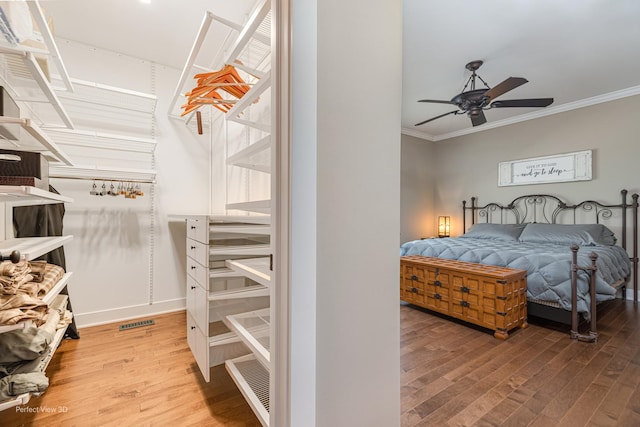 25549 Sara Ct, Channahon, IL 60410 - bedroom featuring wood finished floors, crown molding, and a ceiling fan