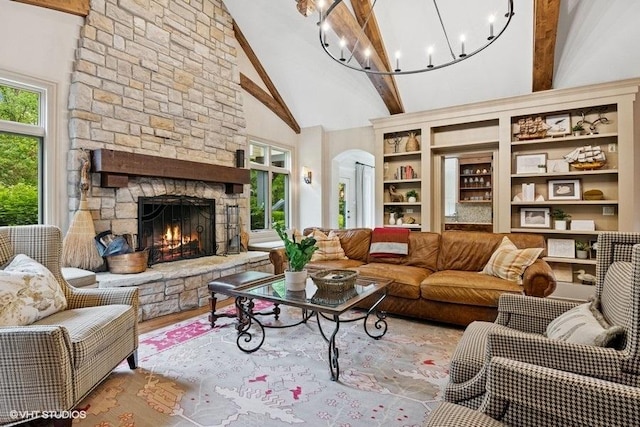 41W590 Bowgren Dr, Campton Hills, IL 60119 - living area with beam ceiling, a stone fireplace, a chandelier, wood finished floors, and arched walkways