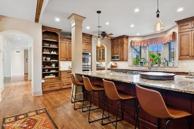41W590 Bowgren Dr, Campton Hills, IL 60119 - kitchen with appliances with stainless steel finishes, backsplash, recessed lighting, light stone countertops, and a breakfast bar area