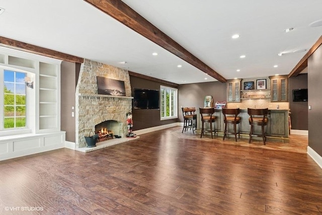 41W590 Bowgren Dr, Campton Hills, IL 60119 - kitchen featuring beamed ceiling, a kitchen bar, wood finished floors, glass insert cabinets, and open floor plan
