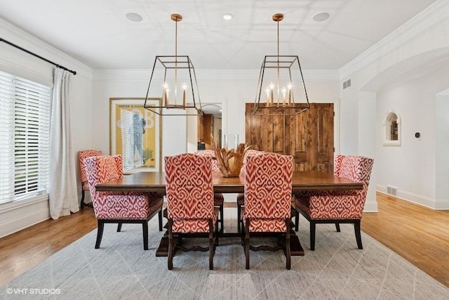 41W590 Bowgren Dr, Campton Hills, IL 60119 - dining room with a chandelier, baseboards, arched walkways, light wood-style floors, and ornamental molding