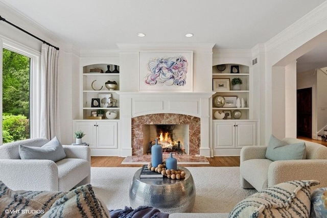 41W590 Bowgren Dr, Campton Hills, IL 60119 - living area with a fireplace, light wood finished floors, built in shelves, and crown molding