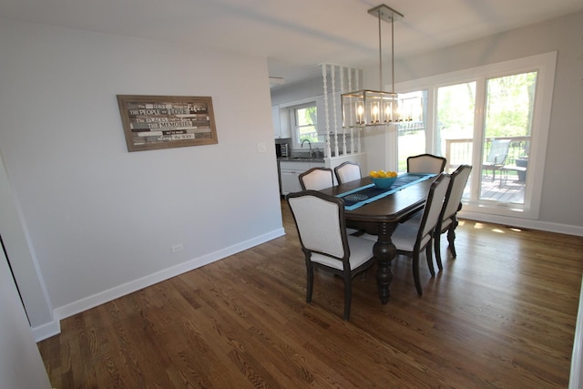 1188 Cypress Ln, Elk Grove Village, IL 60007 - dining area featuring a chandelier, baseboards, and dark wood-type flooring