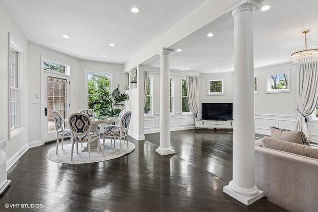 dining area featuring decorative columns, recessed lighting, and wood finished floors