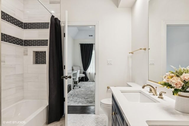 full bath featuring toilet, vanity, and shower / bath combo
