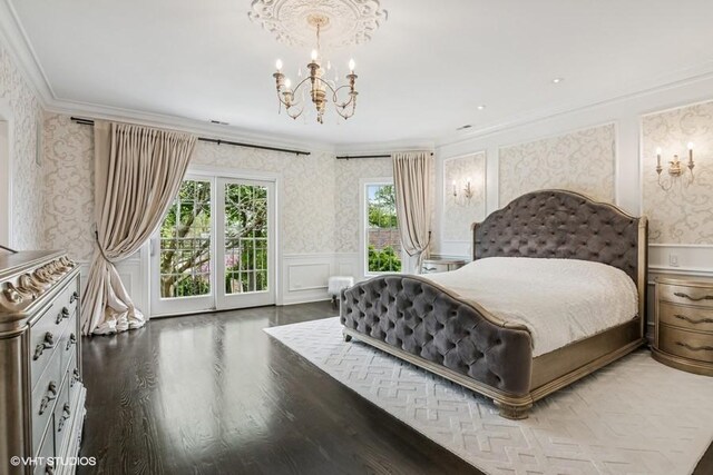 bedroom with wallpapered walls, ornamental molding, access to outside, a chandelier, and a wainscoted wall